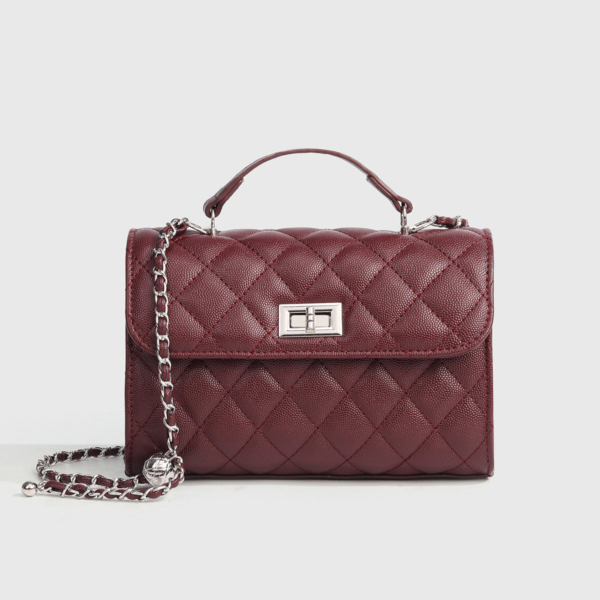 Small structured diamond-quilted flap satchel bag with silver-tone chain strap and turn-lock closure, detail view 8
