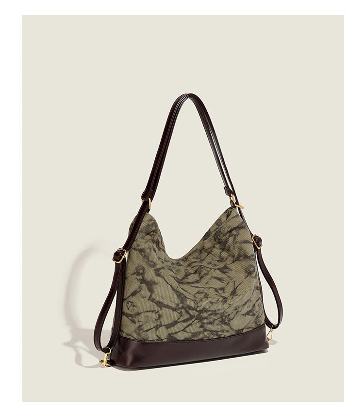 Large ink-wash printed corduroy hobo bag with dark brown leather-look base trim, diagonal front zip pocket, and gold-tone
