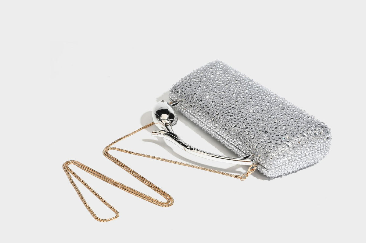 rectangular hard-case rhinestone evening clutch with sculptural gold-tone branch-and-bud top handle and detachable chain
