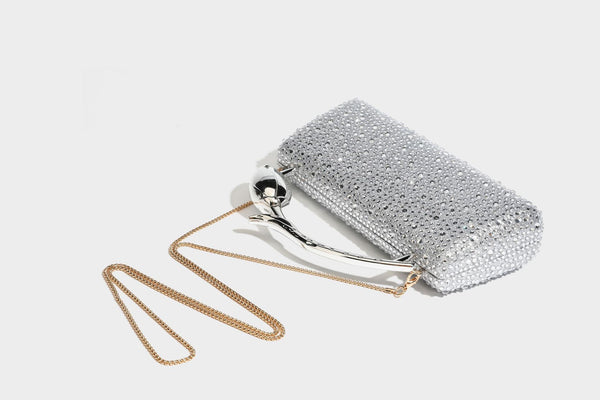 rectangular hard-case rhinestone evening clutch with sculptural gold-tone branch-and-bud top handle and detachable chain