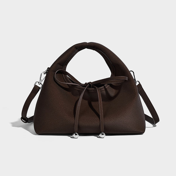 Pebbled matte trapezoid top-handle bag with drawstring bow closure, bead-tipped cords, silver-tone hardware, and detachable
