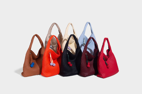 Soft hand-woven slouchy hobo tote bag with knotted tassel charm and single looped shoulder strap, detail view 22