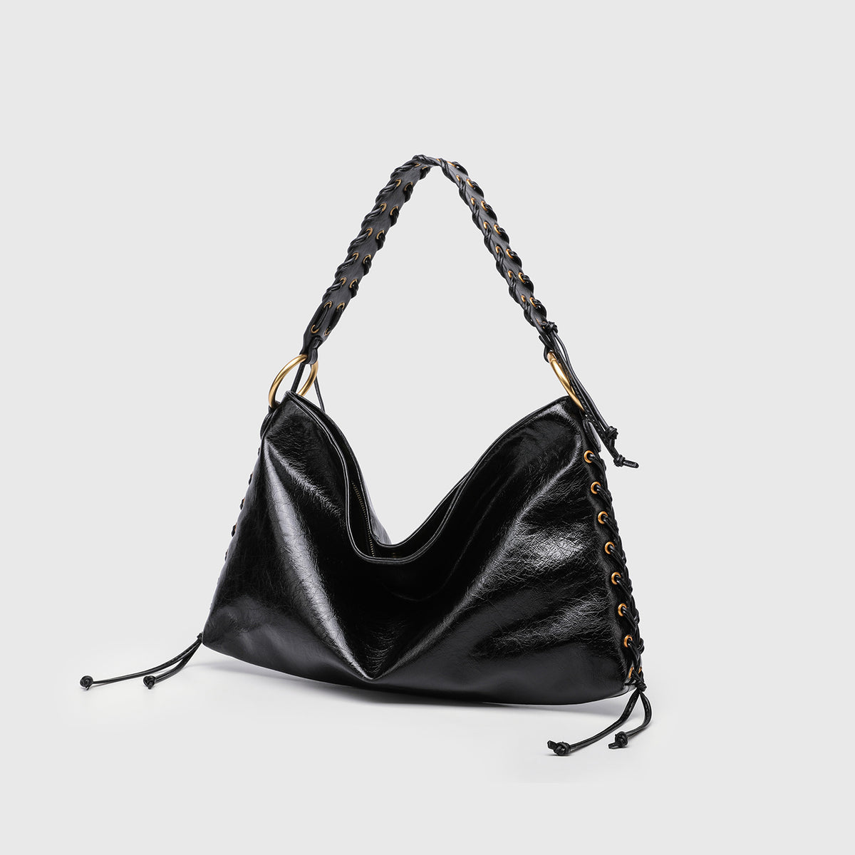 Large slouchy hobo shoulder bag with braided top handle, gold-tone O-ring hardware, and lace-up side cord detailing in