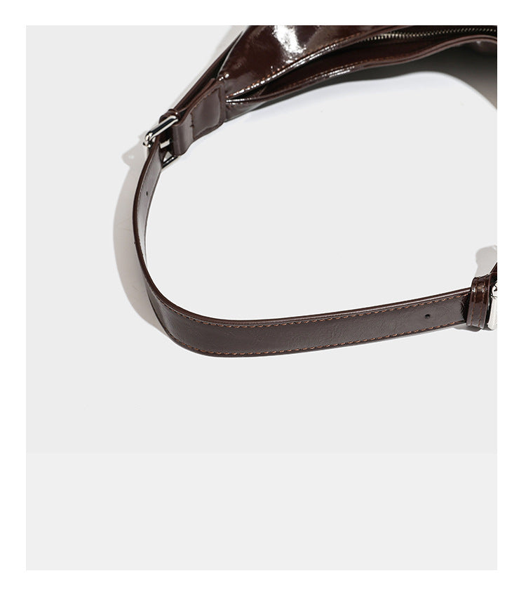 Glänzende dunkelbraune, lässig geschnittene Hobo-Schultertasche mit Riemendetail mit silberfarbenen Ösen, Reißverschlussfach auf der Vorderseite und Herz mit Leopardenmuster