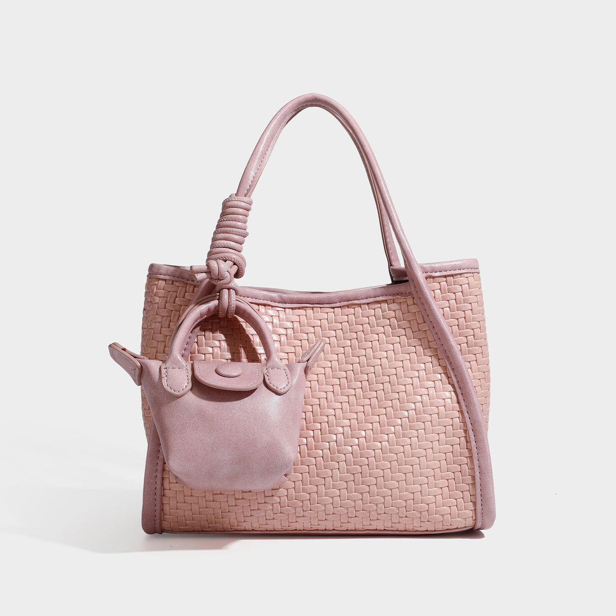 Strukturierte Tote Bag mit Webstruktur in Braun, glatten Besätzen in Lederoptik, geknoteten Tragegriffen und befestigtem Mini-Beutel mit Kordelzug
