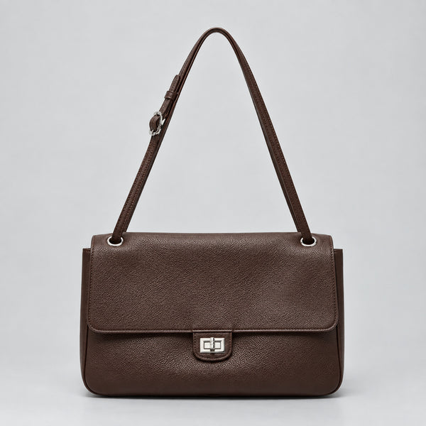Structured black flap shoulder bag with pebbled texture, silver-tone turn-lock closure, and adjustable single shoulder strap