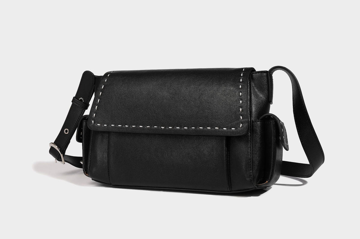 Structured flap crossbody bag in dark brown and cream color-block with white contrast stitching, adjustable shoulder strap