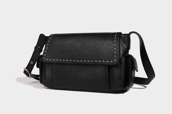 Structured flap crossbody bag in dark brown and cream color-block with white contrast stitching, adjustable shoulder strap