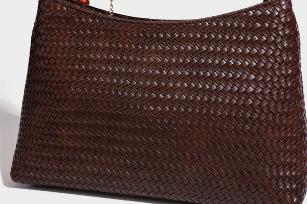Woven-texture hobo shoulder bag in brown with braided top handle, adjustable crossbody strap, front flap pocket, and, detail