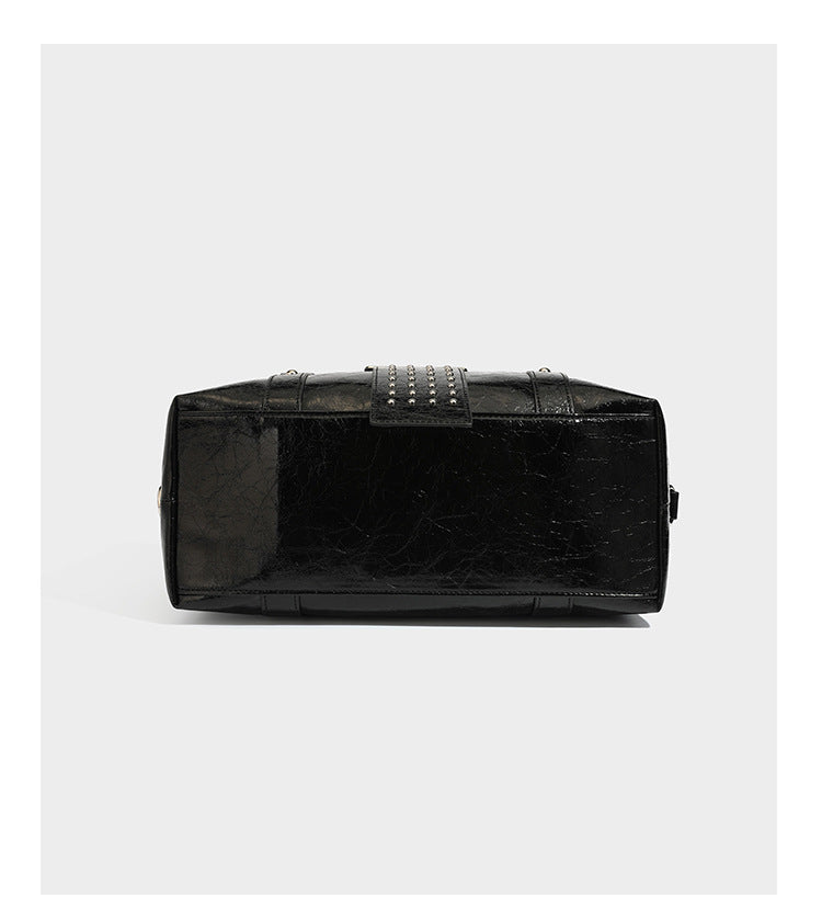 Glossy crinkled barrel handbag with silver stud buckle strap and detachable shoulder strap, detail view 12