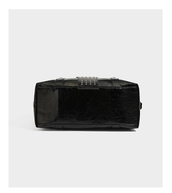 Glossy crinkled barrel handbag with silver stud buckle strap and detachable shoulder strap, detail view 12