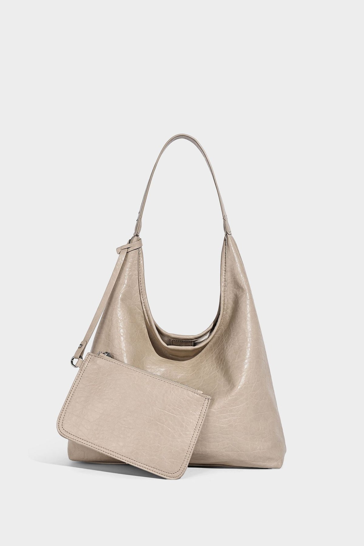 Slouchy hobo shoulder bag in pale yellow glossy pebbled leather-look finish with single shoulder strap and detachable front