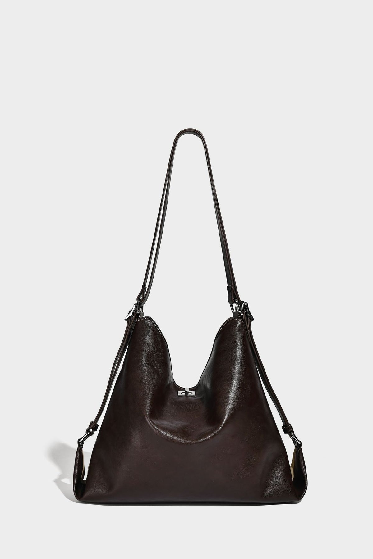 Slouchy hobo tote bag with matte leather-look finish, triangular silhouette, front zip pocket, and adjustable shoulder strap