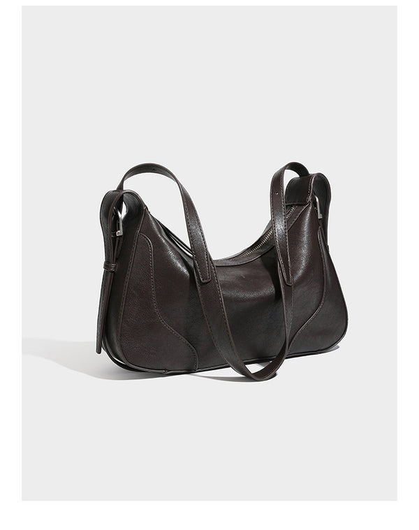 Slouchy crescent hobo shoulder bag in dark brown pebbled leather-look finish with zip top and long shoulder strap, detail