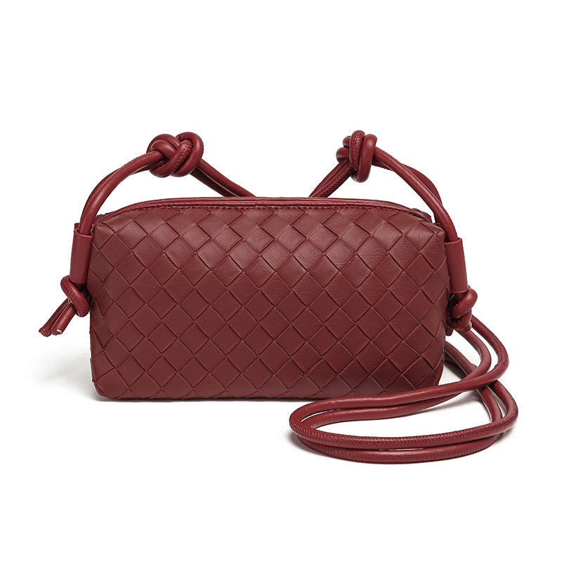 Small rectangular woven-texture mini crossbody bag with knotted rope strap and gold-tone zip closure, detail view 8