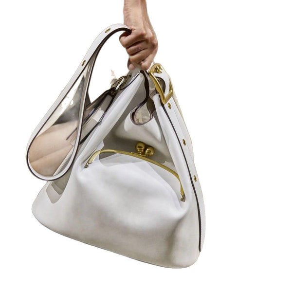 Pebbled textured bucket bag with gold-tone kiss-lock front pocket and adjustable single shoulder strap, detail view 5