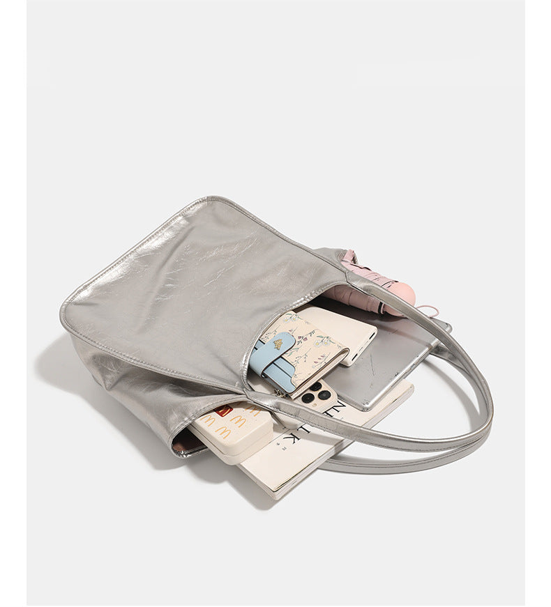 Large open-top shoulder tote bag with glossy crinkled metallic finish and long double straps, detail view 8
