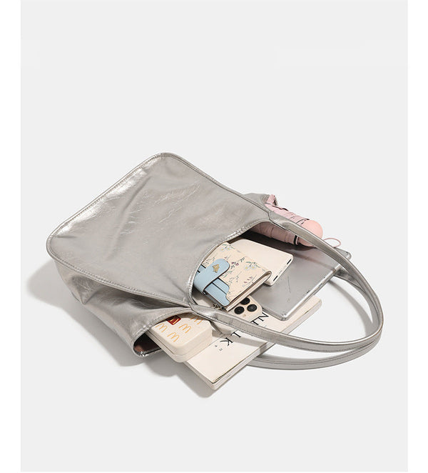 Large open-top shoulder tote bag with glossy crinkled metallic finish and long double straps, detail view 8