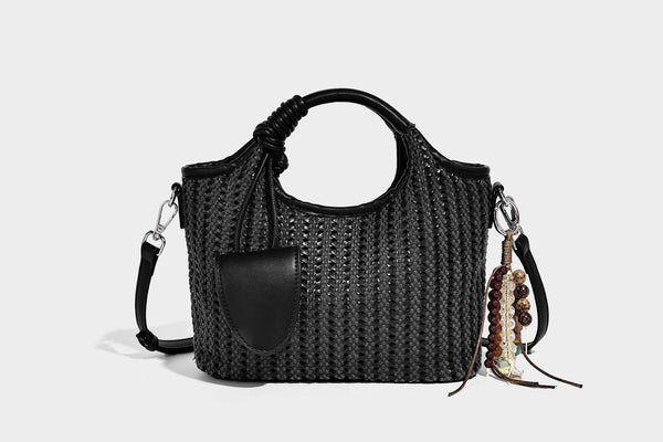 Small structured woven tote crossbody bag with ring top handle, leather-look brown trim, front patch pocket, and detachable