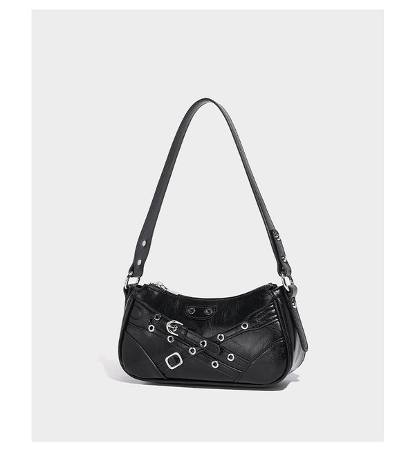 Compact moto-inspired shoulder bag with crisscross grommet strap detail, glossy textured finish, and adjustable crossbody