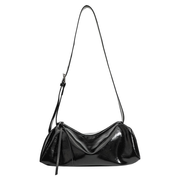 Black glossy leather-look slouchy shoulder bag with gathered top, zip tassel closure, and long adjustable silver-buckle