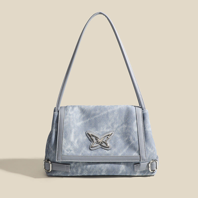 Washed leather-look shoulder tote bag with silver butterfly emblem and buckle hardware, detail view 6