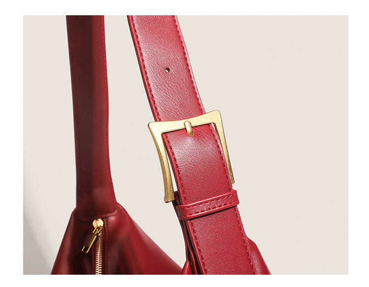 Large slouchy hobo shoulder bag in smooth leather-look finish with single long strap and gold-tone zip closure, detail view