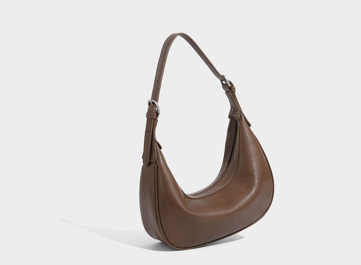 Crescent half-moon shoulder bag in pebbled leather-look finish with adjustable strap and silver-tone hardware, detail view 30