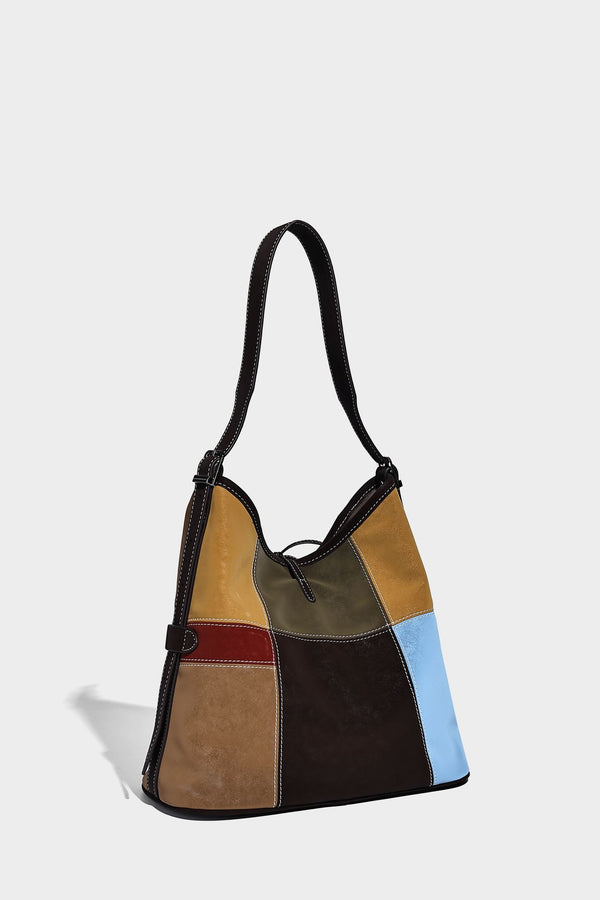 Patchwork bucket tote shoulder bag with tan, dark brown, olive, red, and sky blue color-block panels, white contrast, detail
