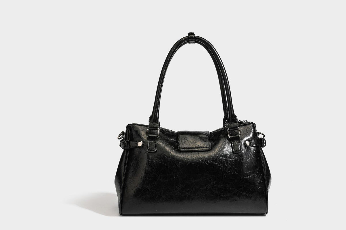 Structured glossy crinkled leather-look satchel with double top handles, front metal-plaque tab, silver-tone hardware, and