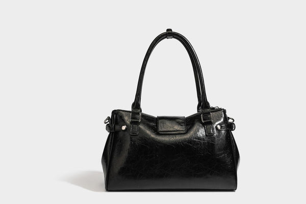 Structured glossy crinkled leather-look satchel with double top handles, front metal-plaque tab, silver-tone hardware, and