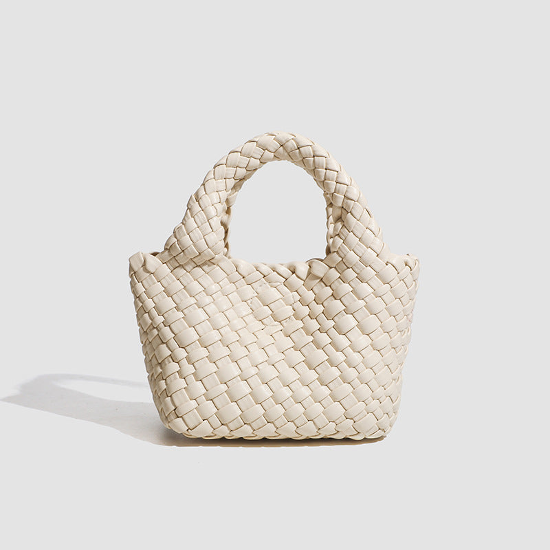 Mini woven basket-weave tote bag with rounded top handles and detachable silver chain strap, front view