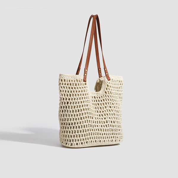 Open-knit woven tote bag with leather-look shoulder straps and brass-tone hardware in off-white, detail view 3