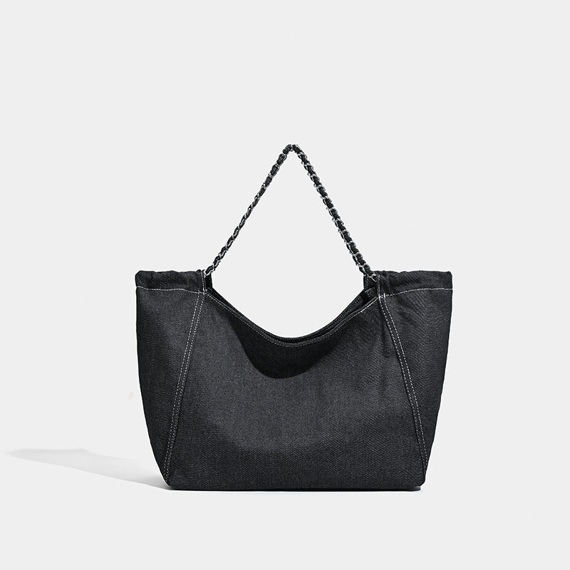 Large slouchy denim tote bag with silver-tone chain strap and contrast topstitching, detail view 7