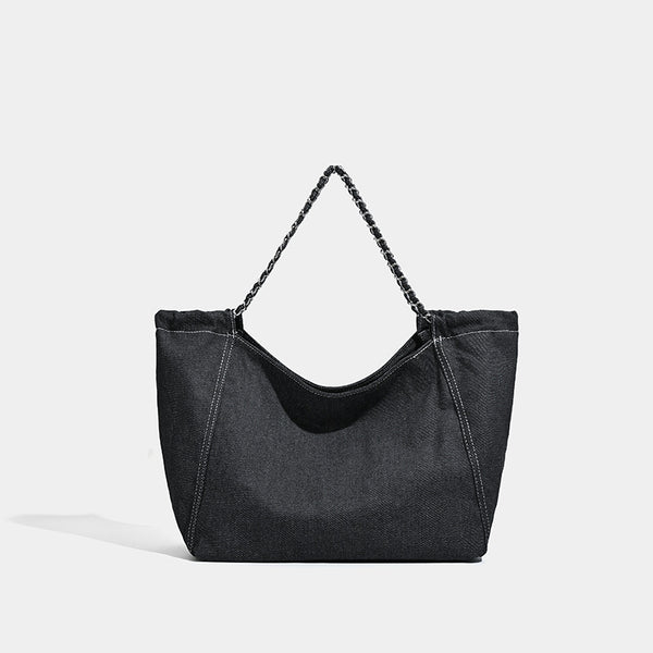 Large slouchy denim tote bag with silver-tone chain strap and contrast topstitching, detail view 7