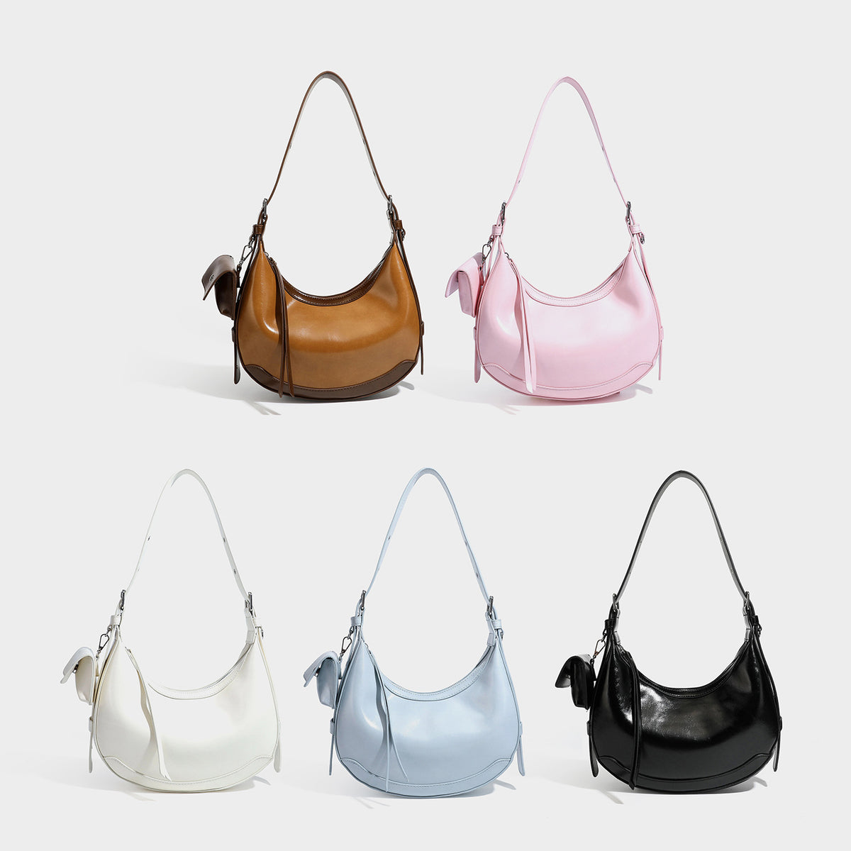 Glossy leather-look crescent hobo shoulder bag with dark contrast trim, silver-tone hardware, and attached mini flap pouch