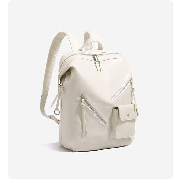 Structured smooth leather-look backpack handbag with dual top zip closure, diagonal front zip pocket, snap-flap mini pocket