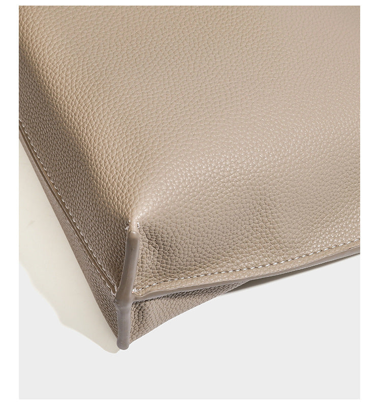 Pebbled leather-look tote bag with front toggle hardware and long shoulder strap, detail view 18