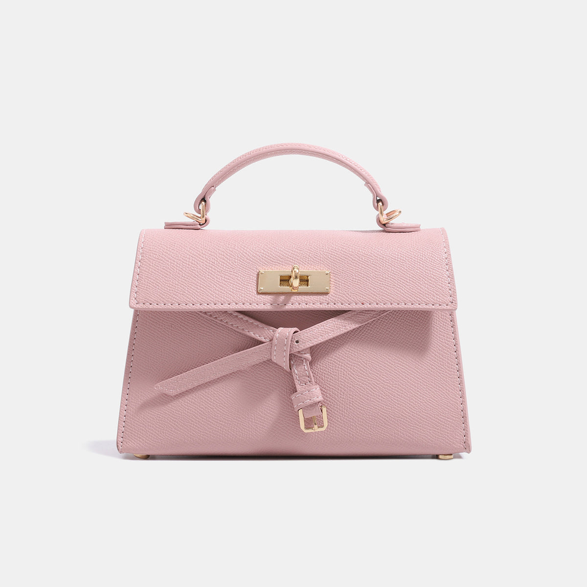 Structured trapezoid leather-look handbag with bow front detail, gold-tone rectangular turn-lock, short top handle, and