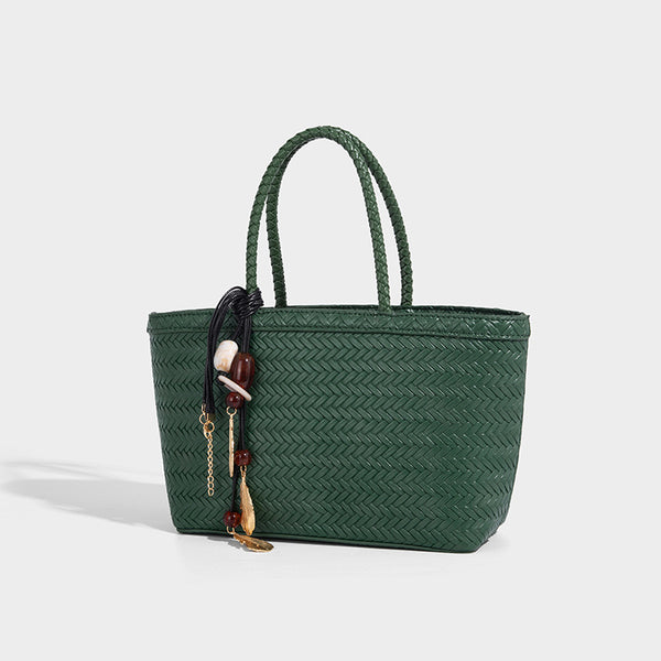 Structured chevron woven leather-look tote bag with braided top handles, gold feather charm, and adjustable shoulder strap