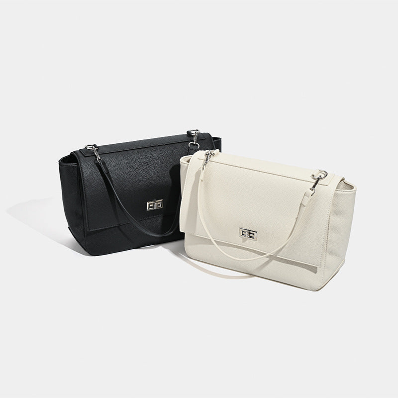 Large structured pebbled-finish flap shoulder bag with silver turn-lock closure and adjustable strap, detail view 2
