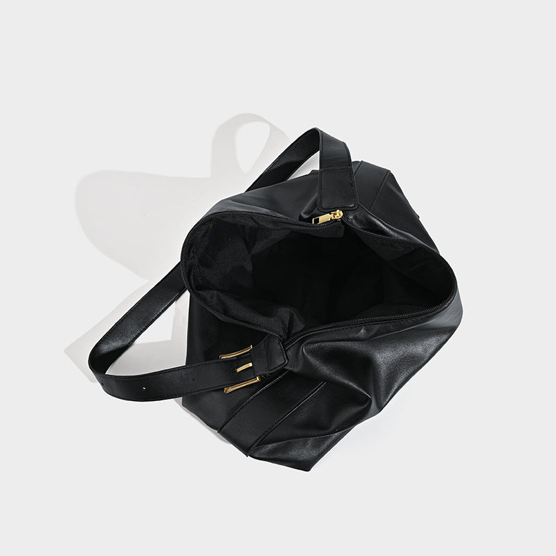 Large slouchy hobo shoulder bag in smooth black leather-look finish with gold-tone buckle hardware and adjustable strap