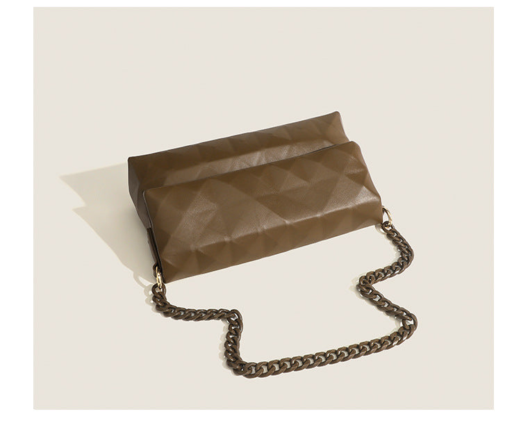 Cream white rectangular flap shoulder bag with geometric faceted surface and chunky tone-on-tone chain strap with gold-tone