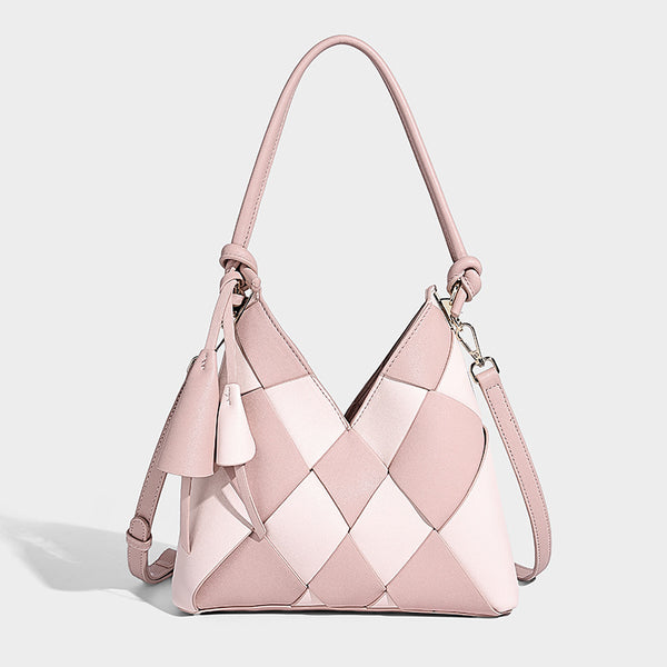 Compact bucket shoulder bag with black-and-white diamond patchwork panels, knotted top handle, gold-tone hardware, and