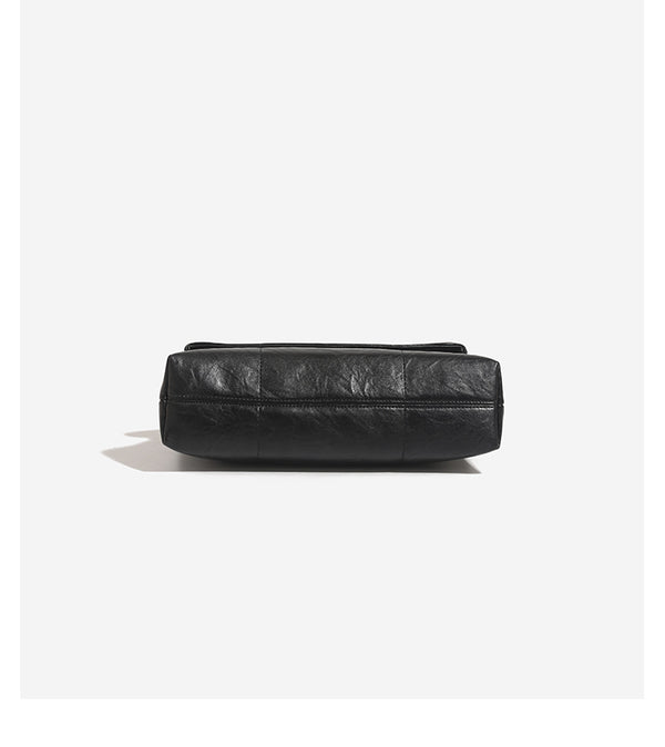 Soft rectangular leather-look convertible shoulder bag with dark curb-chain strap and rounded rectangular metal handle