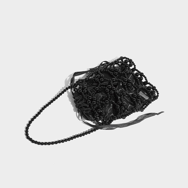 Small pearl-beaded lattice drawstring bucket bag with beaded shoulder strap and ribbon closure, detail view 28