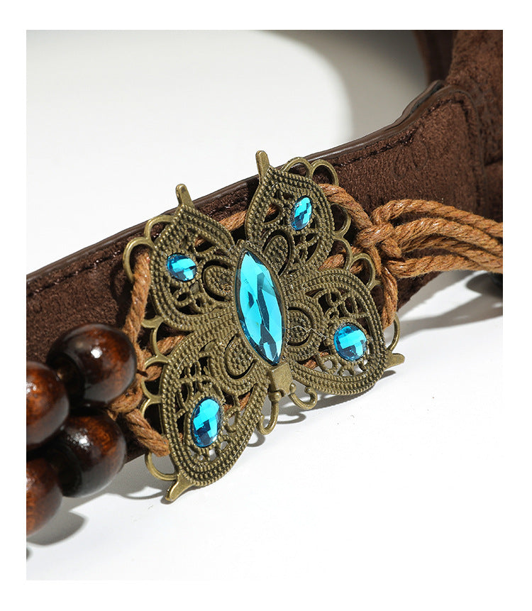 Slouchy boho hobo shoulder bag in embossed brown suede-look finish with beaded strap, cord tassels, and brass-tone leaf