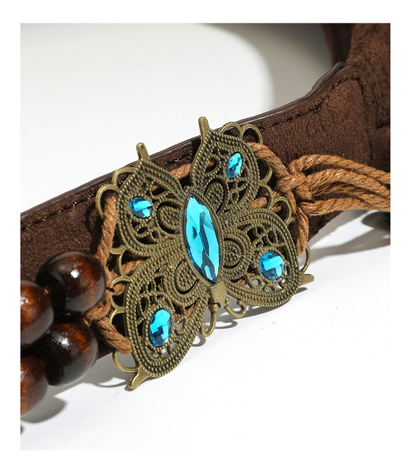 Slouchy boho hobo shoulder bag in embossed brown suede-look finish with beaded strap, cord tassels, and brass-tone leaf