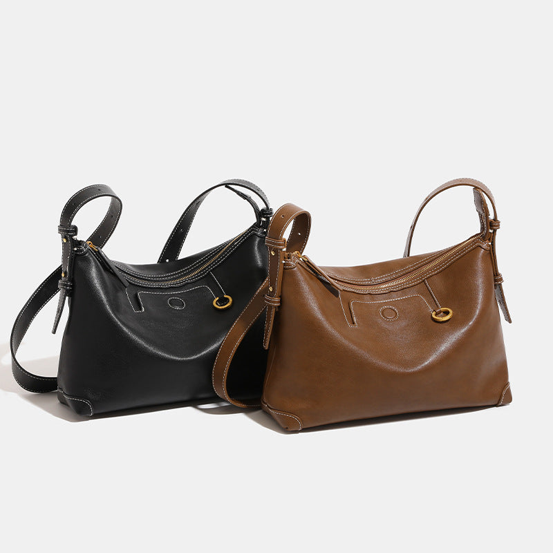 Smooth leather-look hobo bag with gold-tone ring hardware, contrast stitching, top handle and adjustable crossbody strap