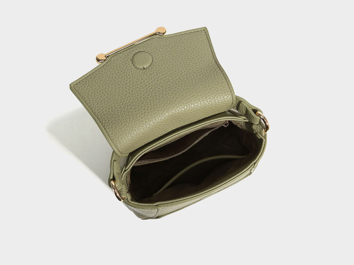Small structured pebbled flap mini satchel with gold-tone bar hardware, short top handle, and detachable crossbody strap